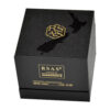 Black textured rigid ampoule box with gold foil logo area and gloss-on-matte exterior graphic