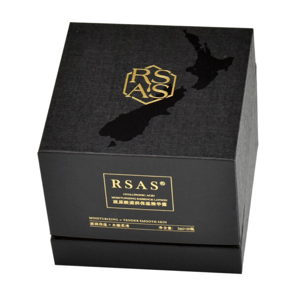 Black textured rigid ampoule box with gold foil logo area and gloss-on-matte exterior graphic