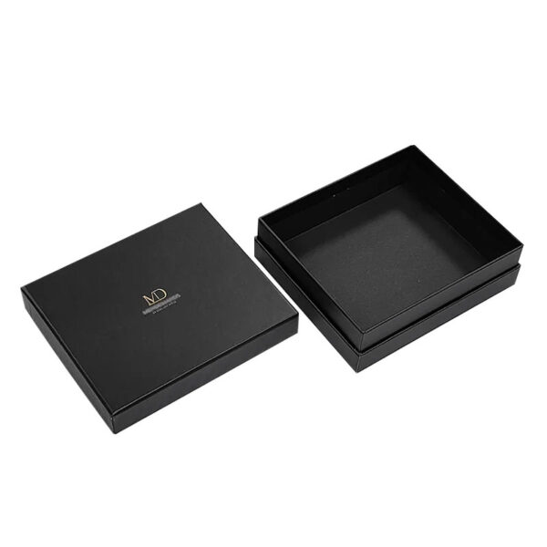 Black two-piece rigid gift boxes shown open and closed with gold foil logos