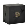 Closed angled facial serum ampoule gift box with black textured wrap and gold foil details