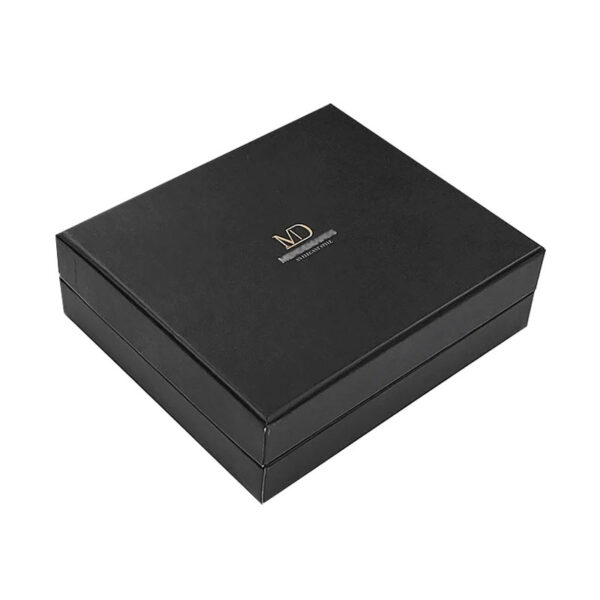 Closed black rigid gift box with lift-off lid and metallic gold logo