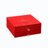 Closed red rigid skincare serum gift box with two stacked drawers and ribbon pull tabs