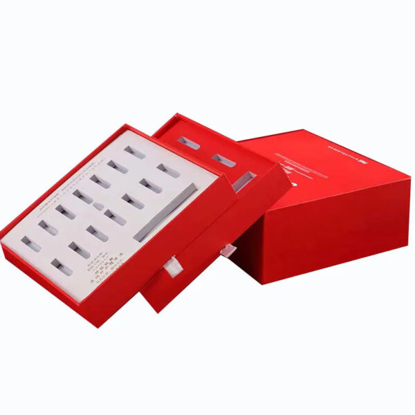 Open skincare ampoule packaging showing two removable drawers with individual die-cut product slots