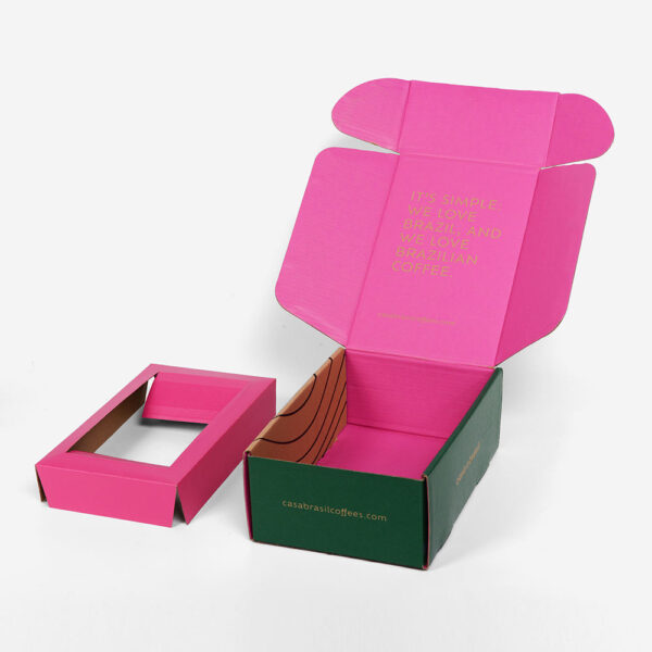 Caja de cartón ondulado verde y rosa para enviar café por correo, con inserto