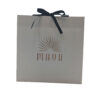 Ivory Paper Shopping Bag with Black Ribbon Bow and Gold Logo
